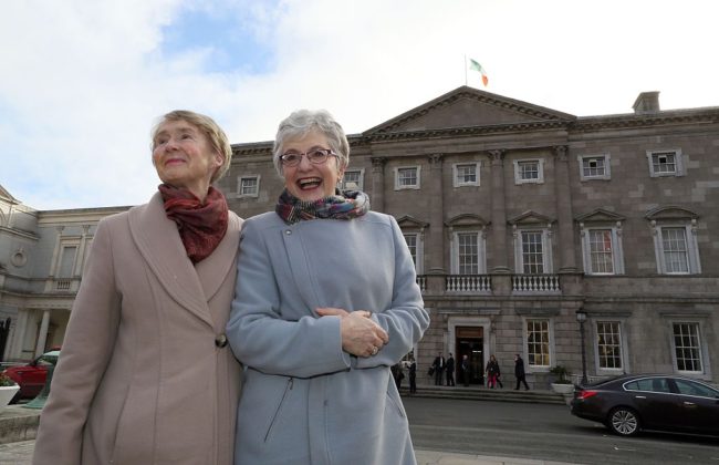 Katherine Zappone (R) arrives with her partner Ann Louise Gilligan (L) for the first day of the Irish parliament in 2016.
