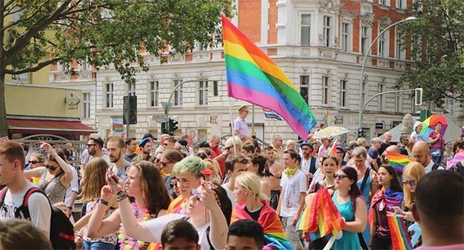 Carrying rainbow flags at Berlin CSD