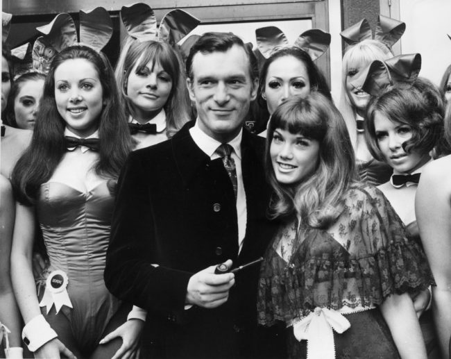 5th September 1969:  Hugh Hefner, head of the Playboy Clubs on a visit to his London club in Park Lane, London. With him is his 19 year old girl friend Barbara Benton and a group of Bunny Girls.  (Photo by Central Press/Getty Images)