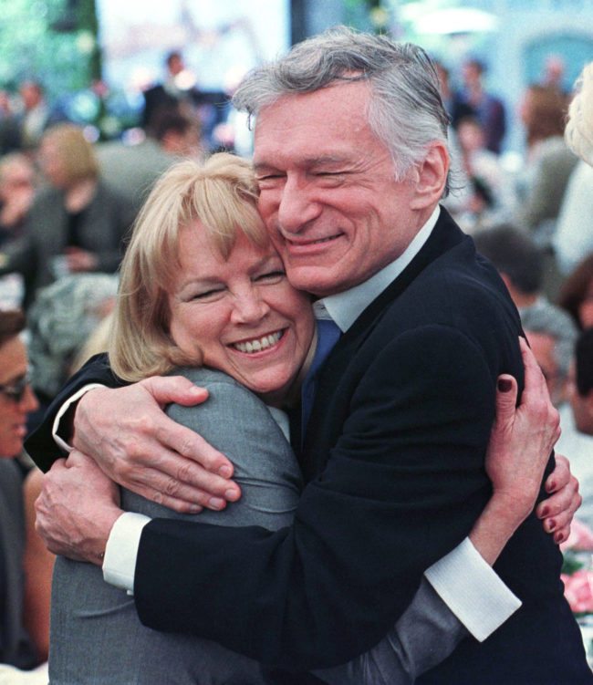 375619 01: Playboy Magazine founder Hugh Hefner and Ellen Stratton, who in 1960 became the magazine's first-ever Playmate of the Year, share a hug at the party announcing Playmate of the Year for 1999, Heather Kozar, at the Playboy Mansion, April 29, 1999 in Hollywood, California. (Photo by David McNew