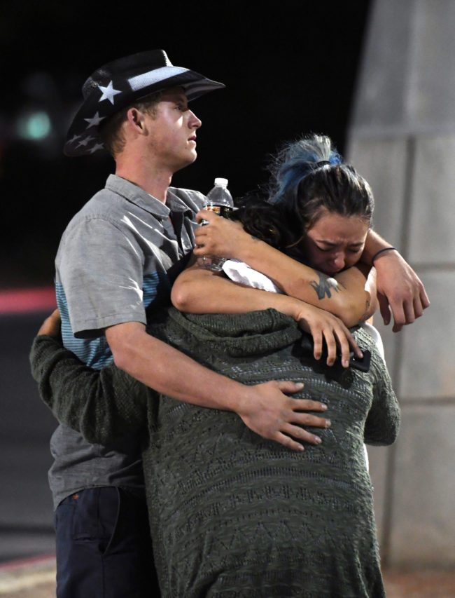LAS VEGAS, NV - OCTOBER 02: People hug and cry outside the Thomas & Mack Center after a mass shooting at the Route 91 Harvest country music festival on October 2, 2017 in Las Vegas, Nevada. A gunman, identified as Stephen Paddock, 64, of Mesquite, Nevada, allegedly opened fire from the Mandalay Bay Resort and Casino on the music festival, leaving at least 50 people dead and hundreds injured. Police have confirmed that one suspect has been shot. The investigation is ongoing. (Photo by Ethan Miller/Getty Images)