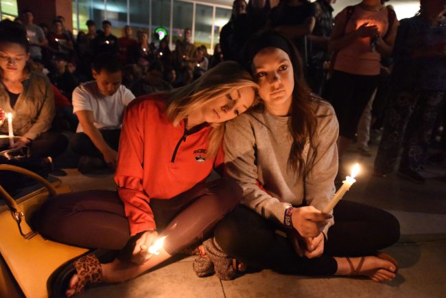 Lindsay Cotterman (L) and Shawna Pieruschka attend a candlelight vigil at the University of Las Vegas student union October 2, 2017, after a gunman killed at least 58 people and wounded more than 500 others when he opened fire on a country music concert in Las Vegas, Nevada late October 1, 2017. / AFP PHOTO / Robyn Beck (Photo credit should read ROBYN BECK/AFP/Getty Images)