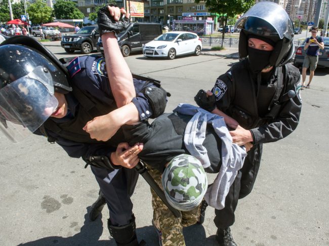 Riot policemen arrest a right-wing activist during a protest against the first "March of Equality" parade in Kiev, since fighting with pro-Moscow rebels broke out in the east of the country last year, on June 6, 2015. At least seven people were injured and more than 20 arrested on June 6, 2015 in Kiev as scuffles broke out between members of a rare Ukrainian gay pride march and their nationalist opponents. AFP PHOTO / VOLODYMYR SHUVAYEV (Photo credit should read VOLODYMYR SHUVAYEV/AFP/Getty Images)