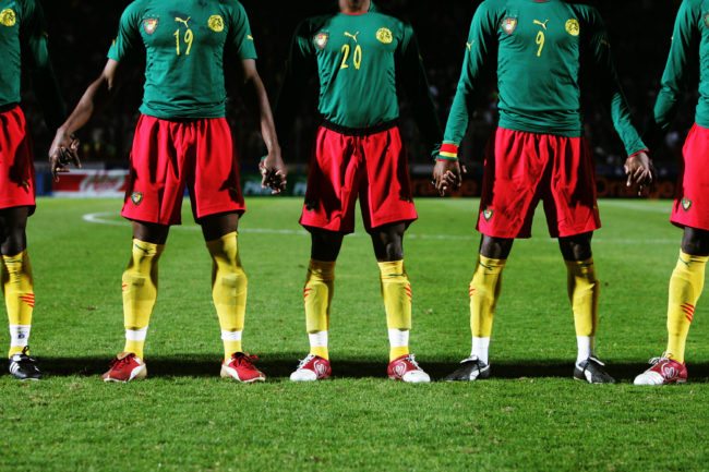PARIS - FEBRUARY 9:  Cameroon players holds hands prior to the International friendly match between Cameron and Senegal at Stade Dominique Duvauchelle on February 8, 2005 in Paris, France. (Photo by Clive Rose/Getty Images)