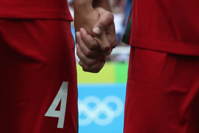 RIO DE JANEIRO, BRAZIL - AUGUST 07:  Players of Portugal holding their hands at  their national anthem for the Men's Group D first round match between Honduras and Portugal during the Rio 2016 Olympic Games at the Olympic Stadium on August 7, 2016 in Rio de Janeiro, Brazil.  (Photo by Alexander Hassenstein/Getty Images)