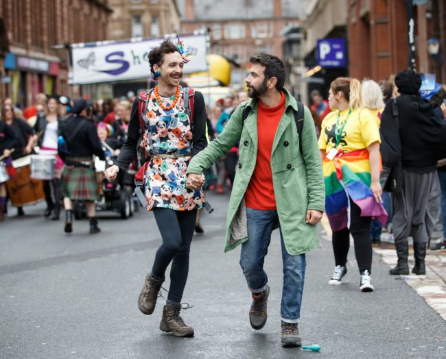 GLASGOW, SCOTLAND - AUGUST 19: Participants hold hands during the Glasgow Pride march on August 19, 2017 in Glasgow, Scotland. The largest festival of LGBTI celebration in Scotland has been held every year in Glasgow since 1996. (Photo by Robert Perry/Getty Images)