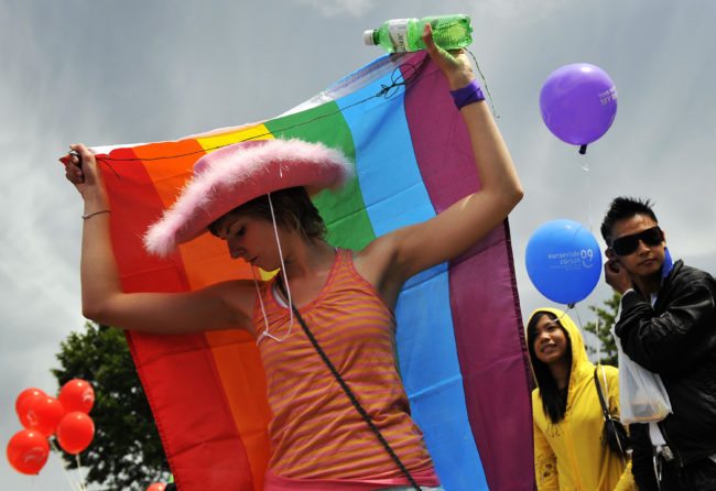 A participant of the 2009 edition of the "Europride" dances with a rainbow flag during the parade on June 6, 2009 in Zurich. Around 50,000 people turned up at the European gay and lesbian parade Europride's annual festival in the Swiss city of Zurich on Saturday, organisers said. The festival, which was held for the first time in London in 1993, takes place in a different European city every year and traditionally attracts participants from all over the continent.  AFP PHOTO / FABRICE COFFRINI (Photo credit should read FABRICE COFFRINI/AFP/Getty Images)