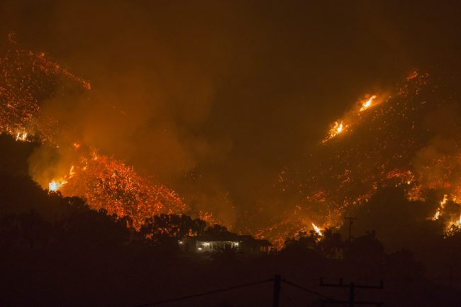 CARPINTERIA, CA - DECEMBER 10: Flames come close to a house as the Thomas Fire advances toward Santa Barbara County seaside communities on December 10, 2017 in Carpinteria, California. The Thomas Fire has grown to 173,000 acres and destroyed at least 754 structures so far. Strong Santa Ana winds have been feeding major wildfires all week, destroying houses and forcing tens of thousands of people to evacuate.  (Photo by David McNew/Getty Images)