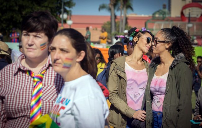 Couples march together as members of the South African Lesbian, Gay, Bisexual and Transgender and Intersex (LGBTI) community take part in the annual Gay Pride Parade, as part of the three-day Durban Pride Festival, on June 24, 2017 in Durban. / AFP PHOTO / RAJESH JANTILAL (Photo credit should read RAJESH JANTILAL/AFP/Getty Images)