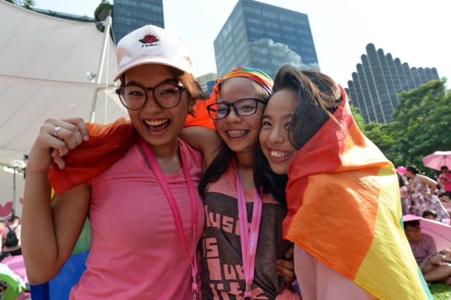 Supporters pose at the annual "Pink Dot" event in a public show of support for the LGBT community at Hong Lim Park in Singapore on July 1, 2017. Thousands of Singaporeans took part in the gay-rights rally on July 1. / AFP PHOTO / Roslan RAHMAN (Photo credit should read ROSLAN RAHMAN/AFP/Getty Images)