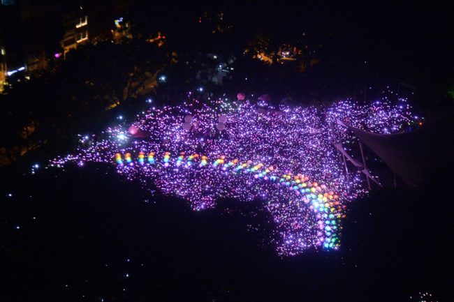 TOPSHOT - Supporters form a rainbow among lights at the annual Pink Dot event in a public show of support for the LGBT community at Hong Lim Park in Singapore on July 1, 2017. Thousands of Singaporeans took part in the gay-rights rally on July 1. / AFP PHOTO / Roslan RAHMAN (Photo credit should read ROSLAN RAHMAN/AFP/Getty Images)