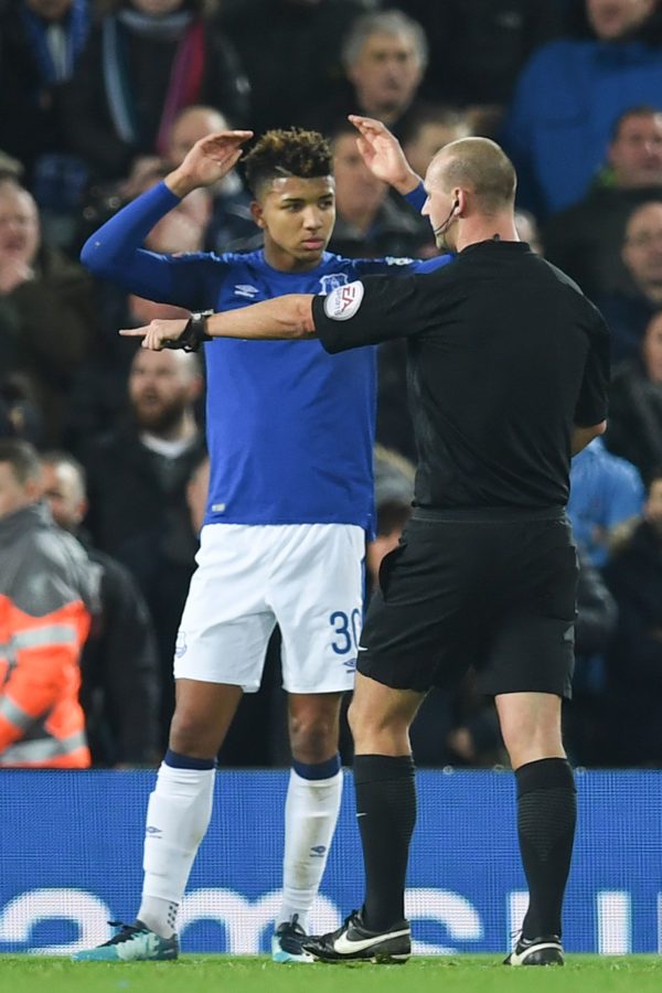 Referee Robert Madley points to the penalty spot to award Liverpool a penalty as Everton's English defender Mason Holgate looks on during the English FA Cup third round football match between Liverpool and Everton at Anfield in Liverpool, north west England on January 5, 2018. / AFP PHOTO / Paul ELLIS / RESTRICTED TO EDITORIAL USE. No use with unauthorized audio, video, data, fixture lists, club/league logos or 'live' services. Online in-match use limited to 75 images, no video emulation. No use in betting, games or single club/league/player publications.  /         (Photo credit should read PAUL ELLIS/AFP/Getty Images)