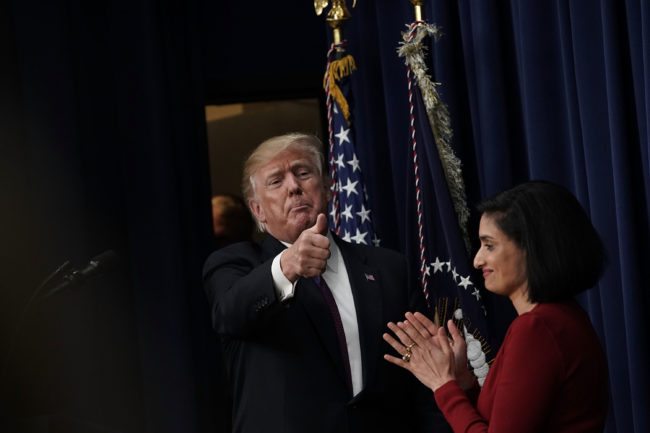 WASHINGTON, DC - JANUARY 16: U.S. President Donald Trump (L) acknowledges the audience as Administrator of the Centers for Medicare and Medicaid Services Seema Verma (R) looks on as he stops by a Conversations with the Women of America panel at the South Court Auditorium of Eisenhower Executive Office Building January 18, 2018 in Washington, DC. The three-part panel features ÒAmerican women from various backgrounds and experiences who will speak with high-level women within the Trump Administration, about what has been accomplished to date to advance women at home, and in the workplace.Ó (Photo by Alex Wong/Getty Images)