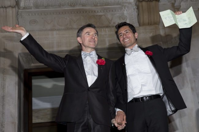 LONDON, ENGLAND - MARCH 29: Gay couple Peter McGraith and David Cabreza leave Islington Town Hall after being married shortly after midnight in one of the UK's first same-sex weddings on March 29, 2014 in London, England. Same sex couples have been able to enter into 'civil partnerships' since 2005, however following a change in the law in July 2013 gay couples are now eligible to marry in England and Wales. A number of gay couples have arranged for their wedding ceremonies to take place shortly after midnight on March 29, 2014 to become some of the first to take advantage of the new law. Parliament's decision to grant same sex couples an equal right to marriage has been met with opposition from religious groups. Gay marriage is currently being debated in Scotland, however the Northern Ireland administration has no plans to make it law.  (Photo by Rob Stothard/Getty Images)
