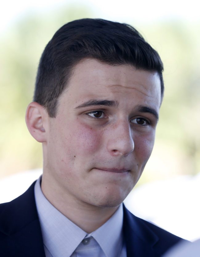 Marjory Stoneman Douglas High School student Cameron Kasky speaks with the media in Parkland, Florida on February 16, 2018, two days after former student Nikolas Cruz opened fire at the school leaving 17 people dead and 15 injured. Stoneman Douglas students have taken to social media to blast defenders of the nation's loose gun laws. In an eloquent essay published online, 17-year-old Cameron Kasky blasted both Republican and Democratic politicians for not doing anything. "We can't ignore the issues of gun control that this tragedy raises," he wrote. "And so, I'm asking -- no, demanding -- we take action now. Why? Because at the end of the day, the students at my school felt one shared experience -- our politicians abandoned us by failing to keep guns out of schools." / AFP PHOTO / RHONA WISE (Photo credit should read RHONA WISE/AFP/Getty Images)