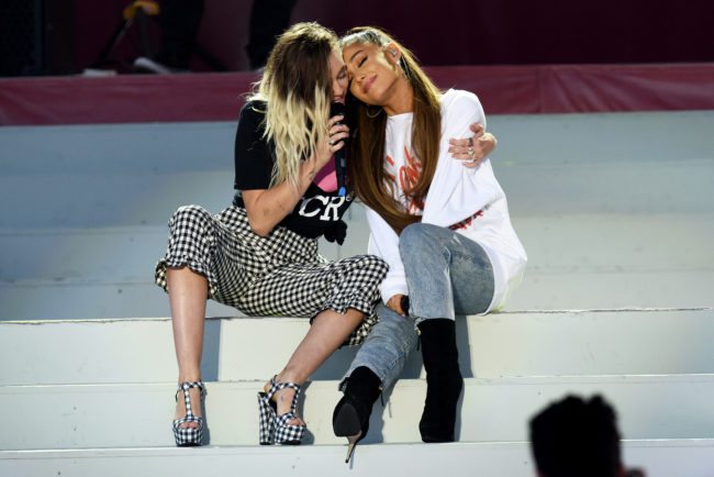 MANCHESTER, ENGLAND - JUNE 04: NO SALES, free for editorial use. In this handout provided by 'One Love Manchester' benefit concert (L) Miley Cyrus and Ariana Grande perform on stage on June 4, 2017 in Manchester, England. Donate at www.redcross.org.uk/love (Photo by Getty Images/Dave Hogan for One Love Manchester)