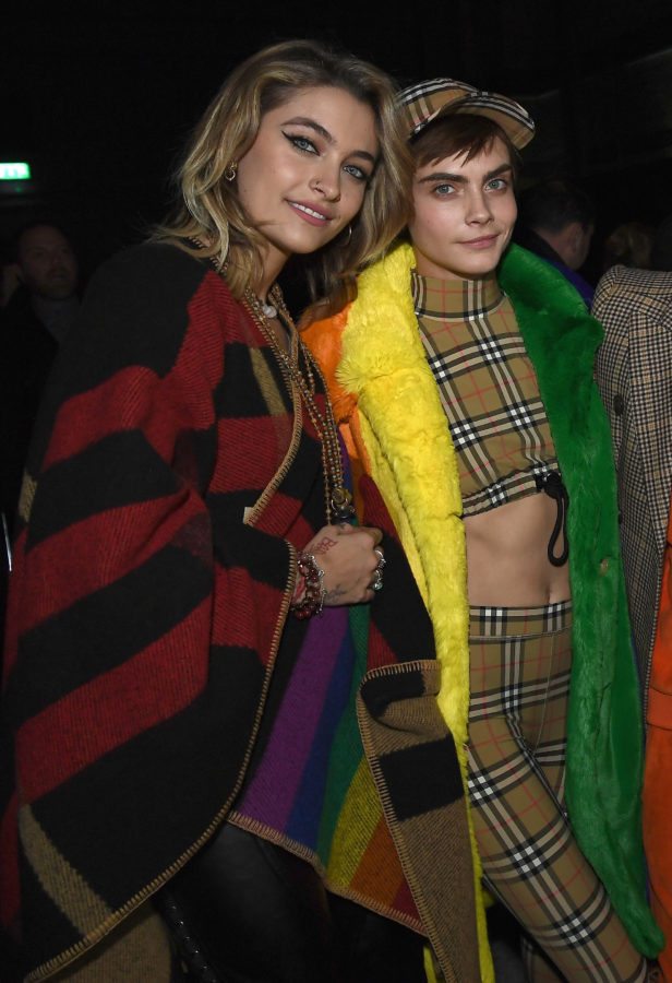 LONDON, ENGLAND - FEBRUARY 17: (EDITORS NOTE: Retransmission of #919595480 with alternate crop.) Paris Jackson and Cara Delevingne wearing Burberry at the Burberry February 2018 show during London Fashion Week at Dimco Buildings on February 17, 2018 in London, England. (Photo by Gareth Cattermole/Getty Images for Burberry)