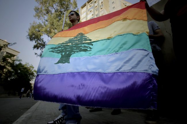 A gay pride flag bearing the cedar tree in the middle of it is carried by human rights activists during an anti-homophobia rally in Beirut on April 30, 2013. Lebanese homosexuals, human rights activists and members from the NGO Helem (the Arabic acronym of "Lebanese Protection for Lesbians, Gays, Bisexuals and Transgenders") rallied to condemn the arrest on the weekend of three gay men and one transgender civilian in the town of Dekwaneh east of Beirut at a nightclub who were allegedly verbally and sexually harassed at the municipality headquarters. AFP PHOTO/JOSEPH EID / AFP PHOTO / Joseph EID (Photo credit should read JOSEPH EID/AFP/Getty Images)