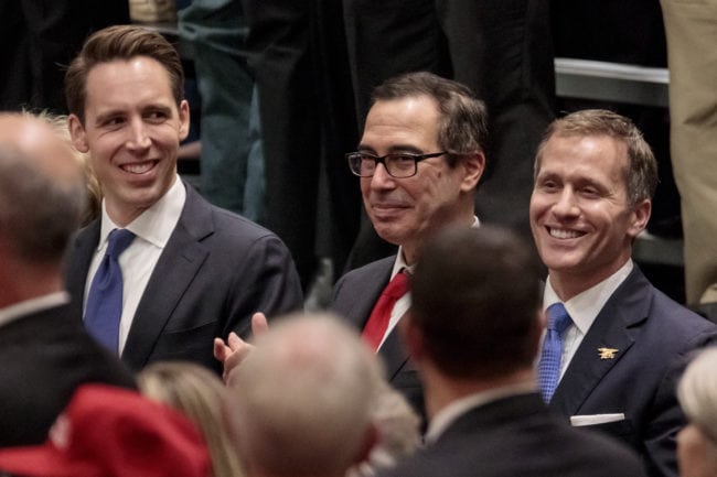ST CHARLES, MO - NOVEMBER 29: Missouri Attorney General and U.S. Senate candidate Josh Hawley (L-R), Treasury Secretary Steven Mnuchin, and Missouri Gov. Eric Greitens listen to U.S. President Donald Trump during a rally at the St. Charles Convention Center on November 29, 2017 in St. Charles, Missouri. Trump promoted the GOP tax reform plan during the speech. (Photo by Whitney Curtis/Getty Images)