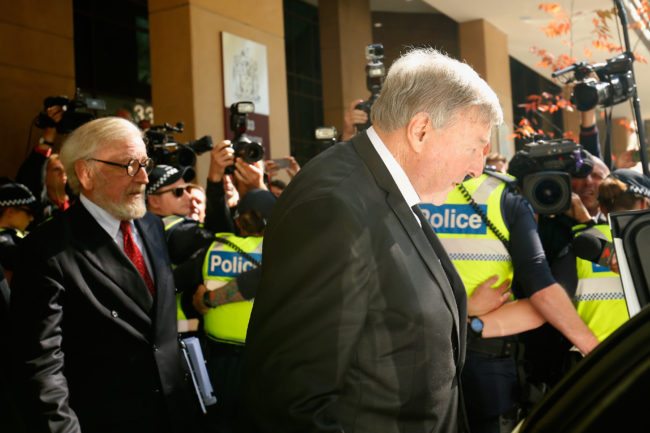 MELBOURNE, AUSTRALIA - MAY 01: Cardinal George Pell walks through a police guard to waiting car outside Melbourne Magistrates' Court on May 1 at Melbourne 1, 2018 in Melbourne, Australia. Cardinal Pell was charged on summons by Victoria Police on 29 June 2017 over multiple allegations of sexual assault. Cardinal Pell is Australia's highest ranking Catholic and the third most senior Catholic at the Vatican, where he was responsible for the church's finances. Cardinal Pell has leave from his Vatican position while he defends the charges. (Photo by Darrian Traynor/Getty Images)