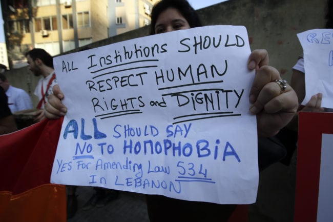 A protestor holds a banner as she attends an anti-homophobia rally in Beirut on April 30, 2013. Lebanese homosexuals, human rights activists and members from the NGO Helem (the Arabic acronym of "Lebanese Protection for Lesbians, Gays, Bisexuals and Transgenders") rallied to condemn the arrest on the weekend of three gay men and one transgender civilian in the town of Dekwaneh east of Beirut at a nightclub who were allegedly verbally and sexually harassed at the municipality headquarters. AFP PHOTO/JOSEPH EID        (Photo credit should read JOSEPH EID/AFP/Getty Images)