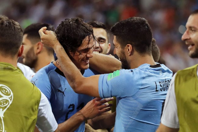 SOCHI, RUSSIA - JUNE 30:  Edinson Cavani of Uruguay celebrates with teammate Luis Suarez after scoring his team's second goal during the 2018 FIFA World Cup Russia Round of 16 match between Uruguay and Portugal at Fisht Stadium on June 30, 2018 in Sochi, Russia.  (Photo by Richard Heathcote/Getty Images)