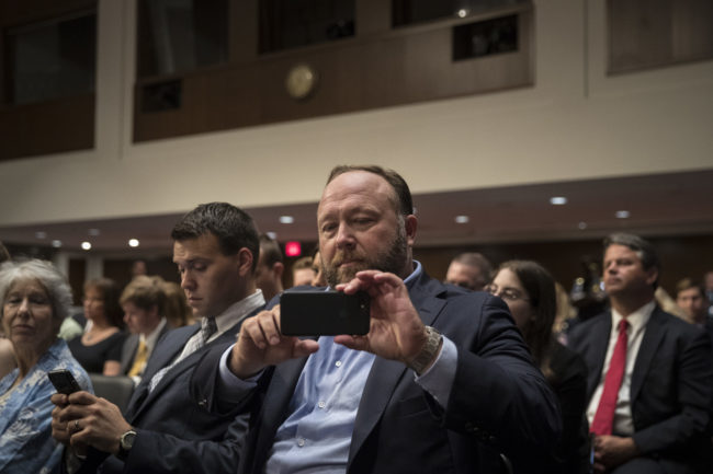 WASHINGTON, DC - SEPTEMBER 5: Alex Jones of InfoWars live streams on his phone during a Senate Intelligence Committee hearing concerning foreign influence operations' use of social media platforms, on Capitol Hill, September 5, 2018 in Washington, DC. Twitter CEO Jack Dorsey and Facebook chief operating officer Sheryl Sandberg faced questions about how foreign operatives use their platforms in attempts to influence and manipulate public opinion. (Photo by Drew Angerer/Getty Images)