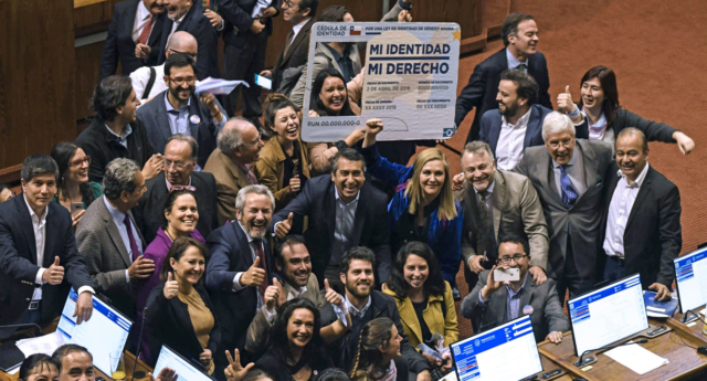 Chilean deputies for the Frente Amplio party, celebrate as they hold a giant fake Chilean Identity card reading "My identity, my right", after voting a gender identity law, during a session at the Deputies Charmber, of the National Congress in Valparaiso, Chile, on September 12, 2018. (Francesco Degasperi/AFP/Getty)