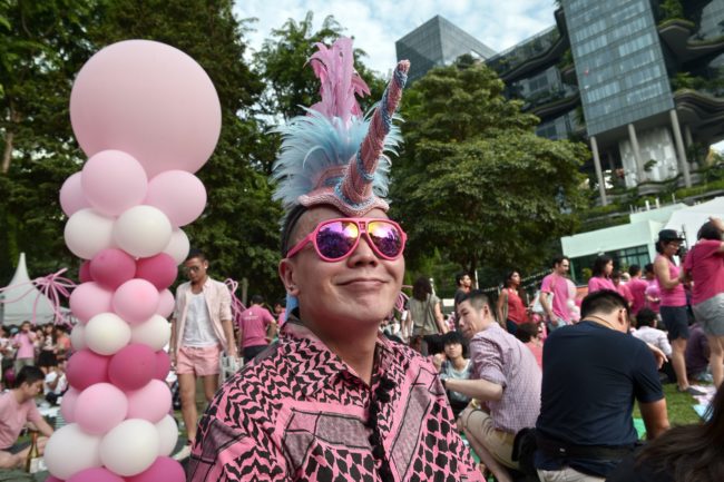 A Singaporean dresses in pink in support of gays and lesbians gather at "Speakers' Corner" in Singapore on June 28, 2014. A gay rights rally was set to kick off in Singapore June 28, with organisers expecting tens of thousands of people to celebrate sexual diversity in the city-state despite fierce opposition from religious conservatives. AFP PHOTO / ROSLAN RAHMAN (Photo credit should read ROSLAN RAHMAN/AFP/Getty Images)