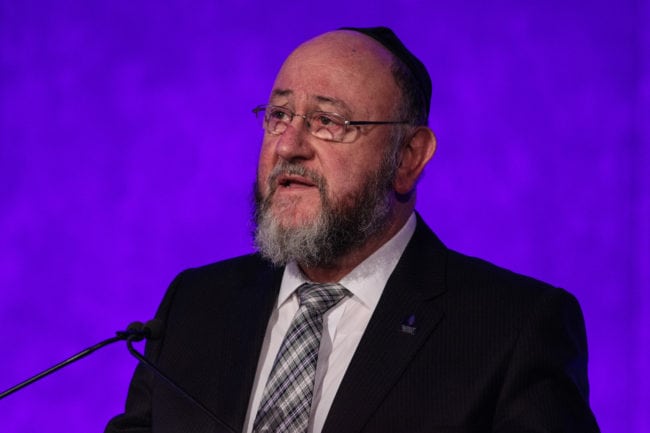 LONDON, ENGLAND - JANUARY 26: Chief Rabbi Ephraim Mirvis speaks at a National Holocaust Memorial Day event at the Queen Elizabeth II Conference Centre on January 26, 2017 in London, England. The commemorative event, attended by religious leaders, heard testimonies from survivors of the Holocaust, in which millions of predominantly Jewish people were killed. National Holocaust Day on February 27 marks the 72nd anniversary of the liberation of the Auschwitz concentration camp by Soviet troops. (Photo by Jack Taylor/Getty Images)
