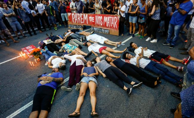 People perform in a street during a rally against the murder of Brazilian councilwoman and activist Marielle Franco, in Sao Paulo Brazil on March 15, 2018. Brazilians mourned for the Rio de Janeiro councilwoman and outspoken critic of police brutality who was shot in the city center in an assassination-style killing on the eve.  / AFP PHOTO / Miguel SCHINCARIOL        (Photo credit should read MIGUEL SCHINCARIOL/AFP/Getty Images)