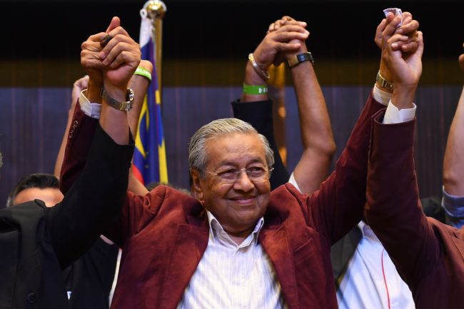 Former Malaysian prime minister and opposition candidate Mahathir Mohamad celebrates with other leaders of his coalition during a press conference in Kuala Lumpur on early May 10, 2018. - Malaysia's opposition alliance headed by veteran ex-leader Mahathir Mohamad, 92, has won a historic election victory, official results showed on May 10, ending the six-decade rule of the Barisan Nasional (BN) coalition. (Photo by Manan VATSYAYANA / AFP) (Photo credit should read MANAN VATSYAYANA/AFP/Getty Images)