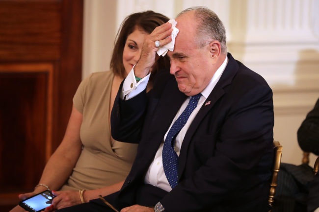 WASHINGTON, DC - JULY 09:  Former New York City Mayor Rudy Giuliani (R) and his wife Judith Giuliani arrive in the East Room before U.S. President Donald Trump introduces Judge Brett Kavanaugh as his nominee to the United States Supreme Court at the White House July 9, 2018 in Washington, DC. Pending confirmation by the U.S. Senate, Kavanaugh would succeed Associate Justice Anthony Kennedy, 81, who is retiring after 30 years of service on the high court.  (Photo by Chip Somodevilla/Getty Images)