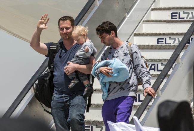 Israeli gay couple disembark plane after being repatriated from Nepal.