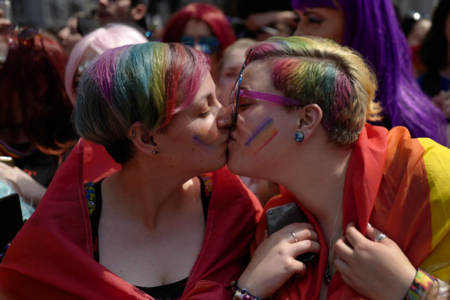 A lesbian couple kissing. Trump supporter Coach Dave has claimed "unattractive" women become lesbians because "it's hard to find a man to love them" 
