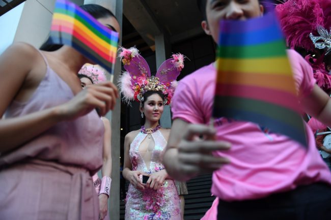 Participants wave rainbow flags during an LGBT+ rights rally in Bangkok, Thailand