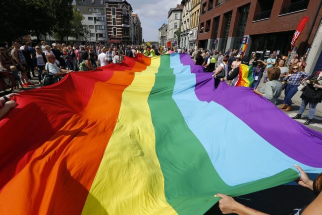 Pride flag held aloft at Belgium Pride. Cariad Jones has been hounded off Twitter by anti-trans trolls
