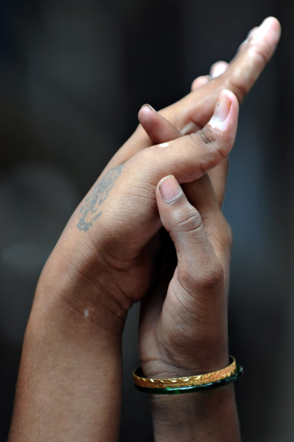 Two women holding hands, representing the gay asylum seeker couple who were asked intrusive questions by Australian authorities