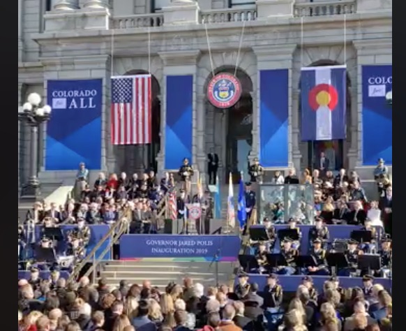 The stage at the Jared Polis inauguration was dressed with a rainbow