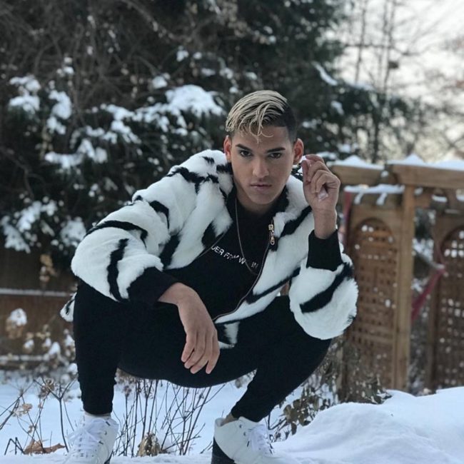 Kevin Fret squatting in a snowy scene