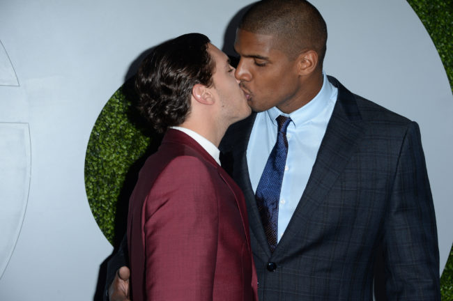 Vito Cammisano (L) and football player Michael Sam kissing as they attend the 2014 GQ Men Of the Year. 