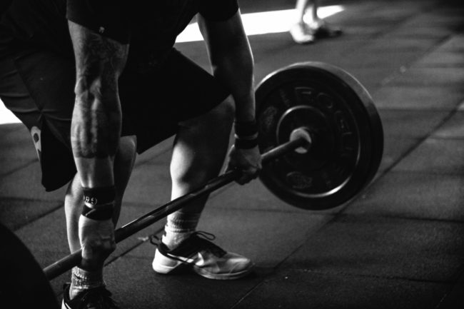 USA Powerlifting: A person lifts weights.