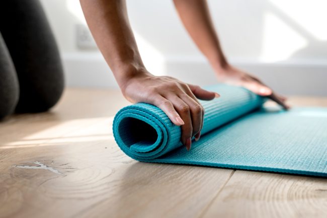 David Lloyd gym: File photo. A woman rolls a yoga mat