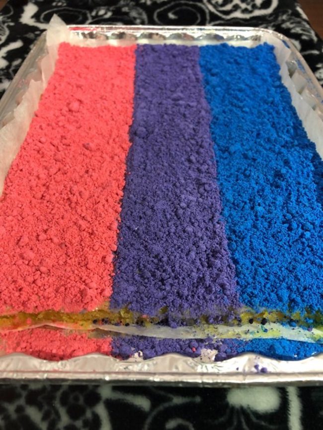 Bisexual lemon bars: A collection of lemon bars decorated in the colours of the bisexual flag.
