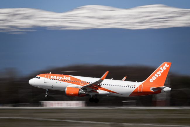 An EasyJet Airbus A320 commercial plane with registration HB-JXF is landing at Geneva Airport on March 22, 2019 in Geneva.
