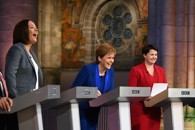 Kezia Dugdale, Nicola Sturgeon, and Ruth Davidson laughing during BBC Scotland's live election debate 