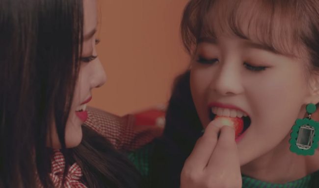 A still from Loona video Heart Attack, which shows group members Chuu and Yves getting into a lesbian relationship.