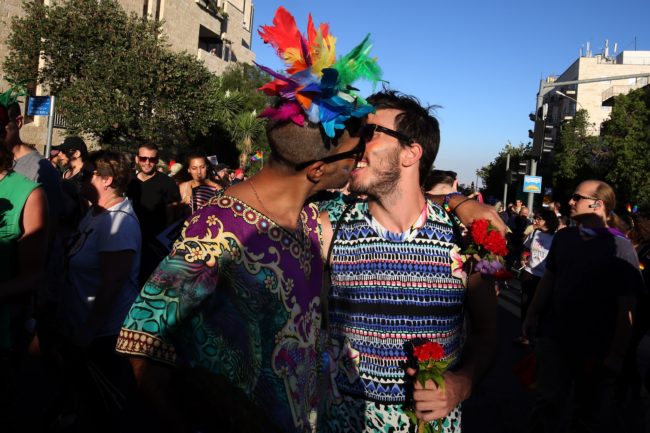 An Israeli couple kiss during the annual Jerusalem Pride Parade on July 21, 2016.